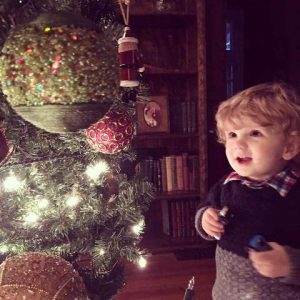 Small child gazing in awe at a Christmas Tree