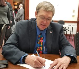 Don Cole signing papers to qualify for office