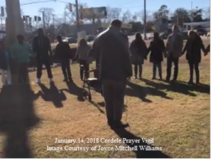 Community praying in Cordele, GA