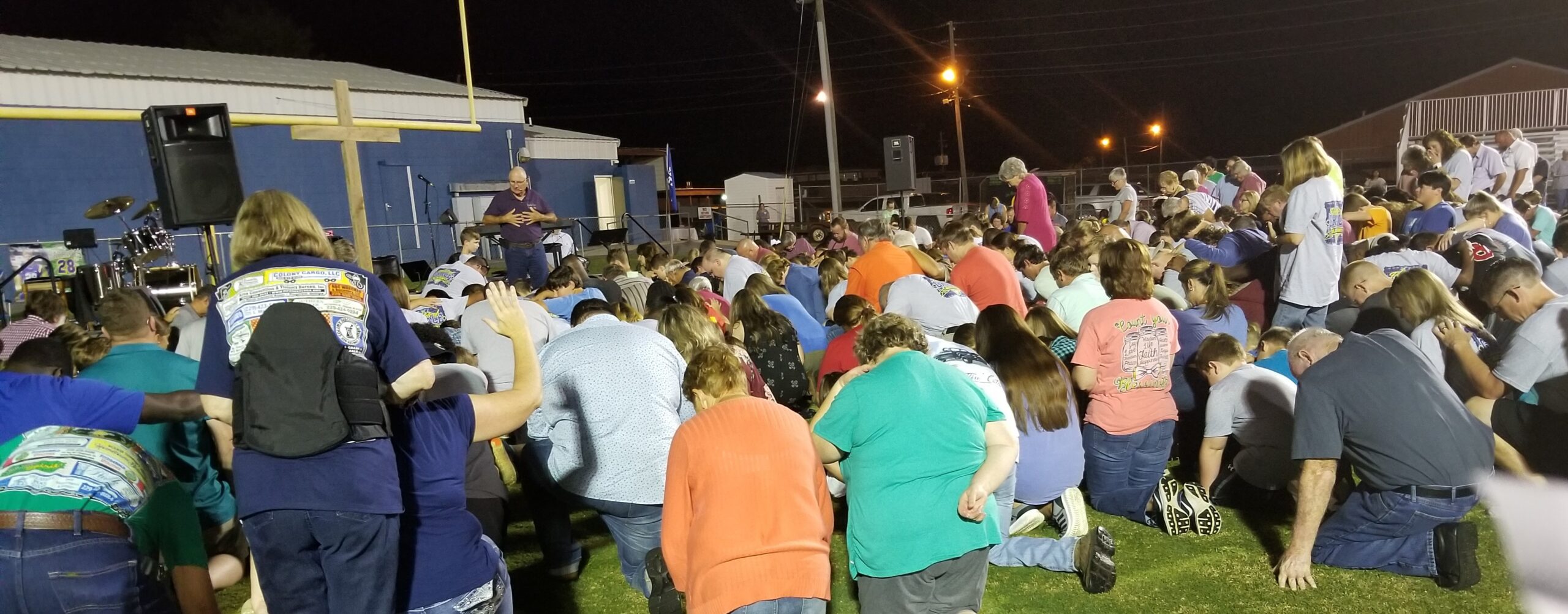 Crowd of people kneeling in prayer