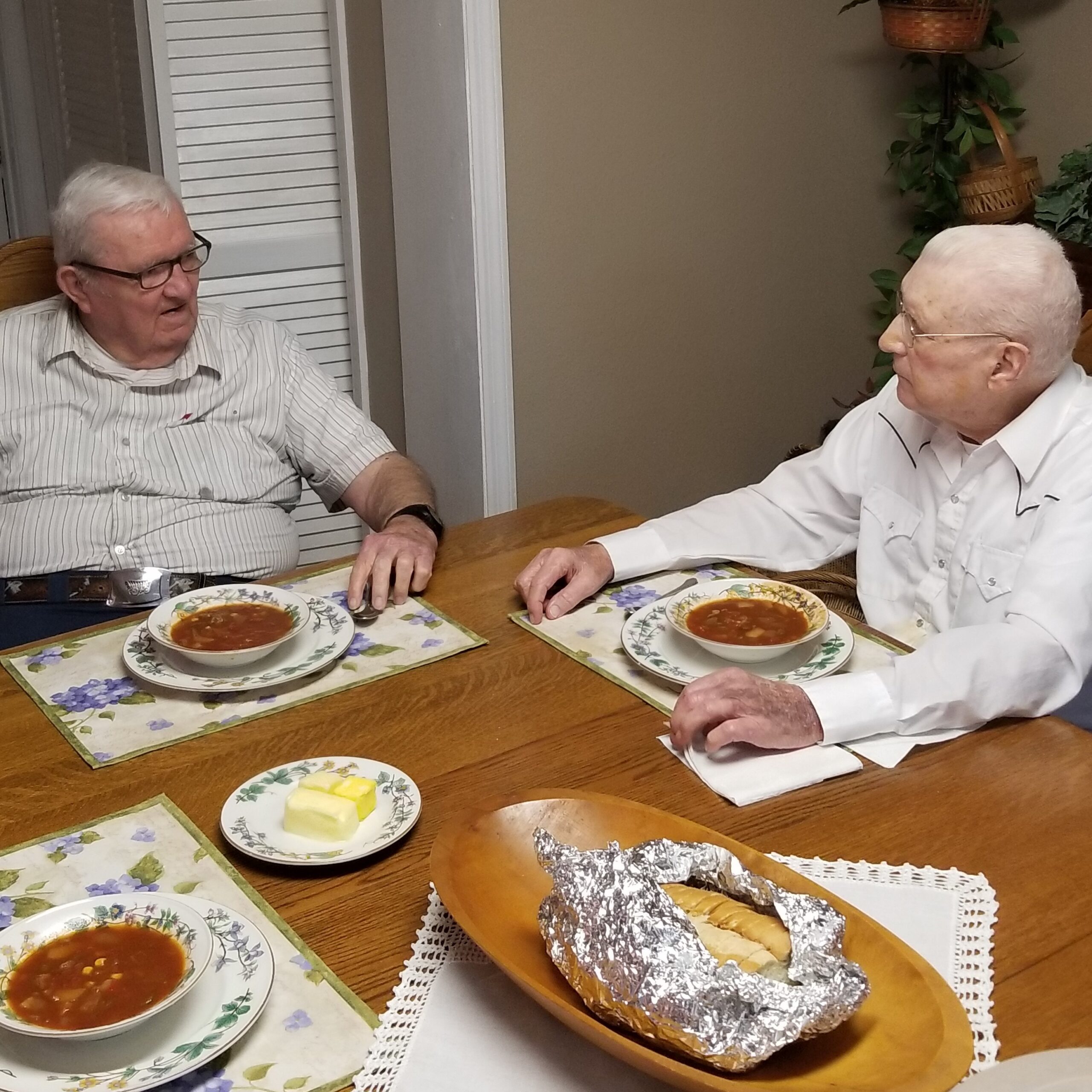 Two WWII Vets talking and eating soup