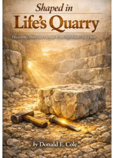 Picture of a large stone in a quarry with hammer and chisel for shaping. 